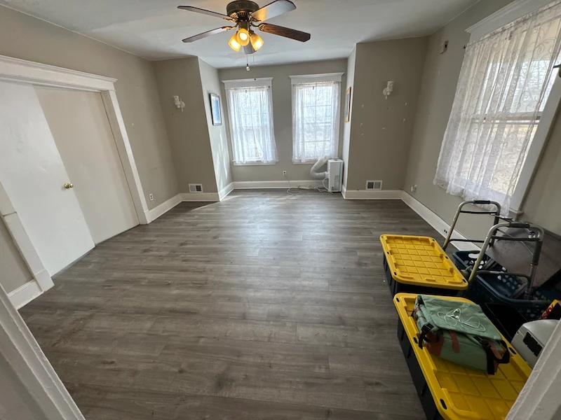 After photo of the same apartment room completely cleared of furniture and junk by JunkDoctors.
