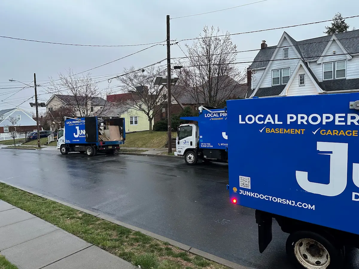 Three Junk Doctors NJ trucks lined up for a large-scale residential appliance removal and property cleanout in a North NJ neighborhood.