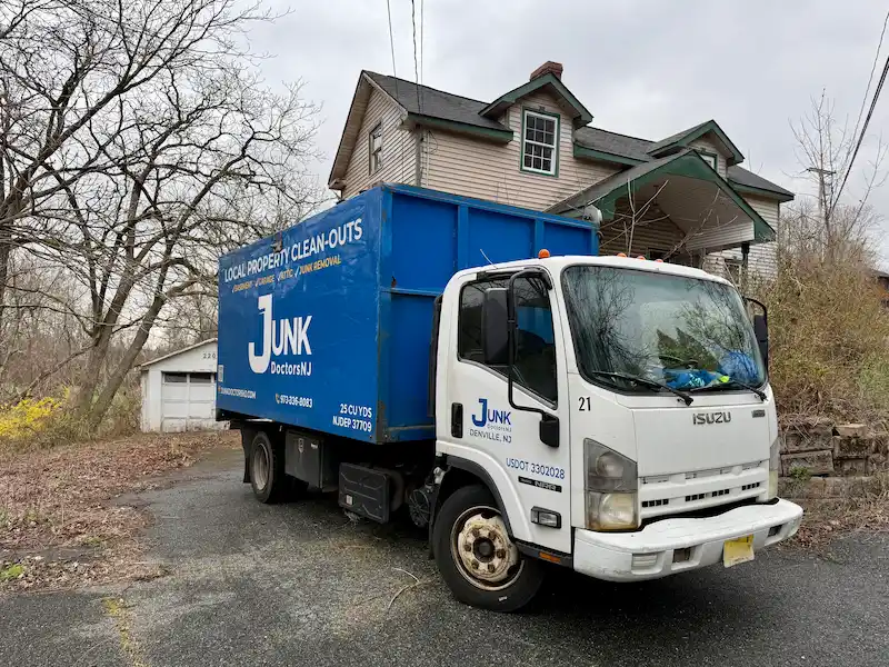 Junk Doctors NJ truck parked at a residential home for a professional attic cleanout and junk removal job in Denville.