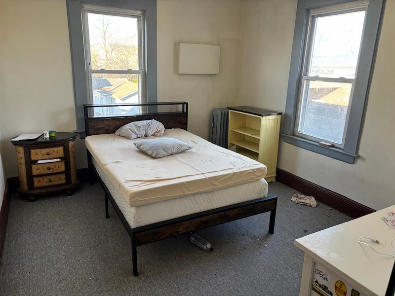 A typical residential bedroom in North NJ featuring a mattress, bed frame, and nightstand staged for professional removal and eco-friendly disposal by Junk Doctors NJ.