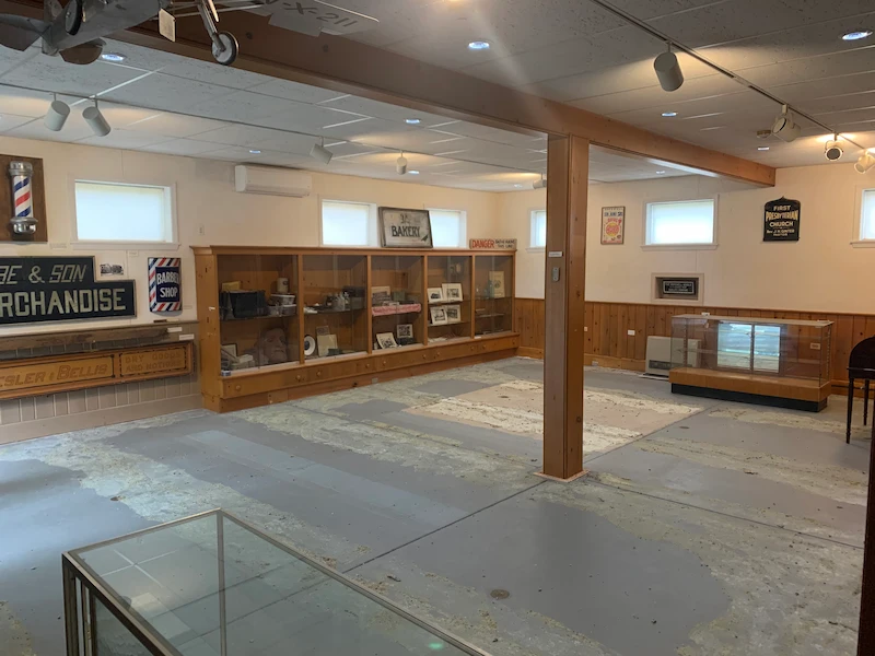 After photo of a library room with all carpet removed and concrete subfloor swept clean of debris.
