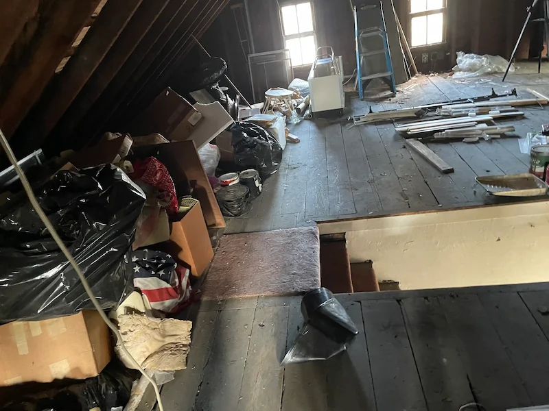 Cluttered attic before cleanout