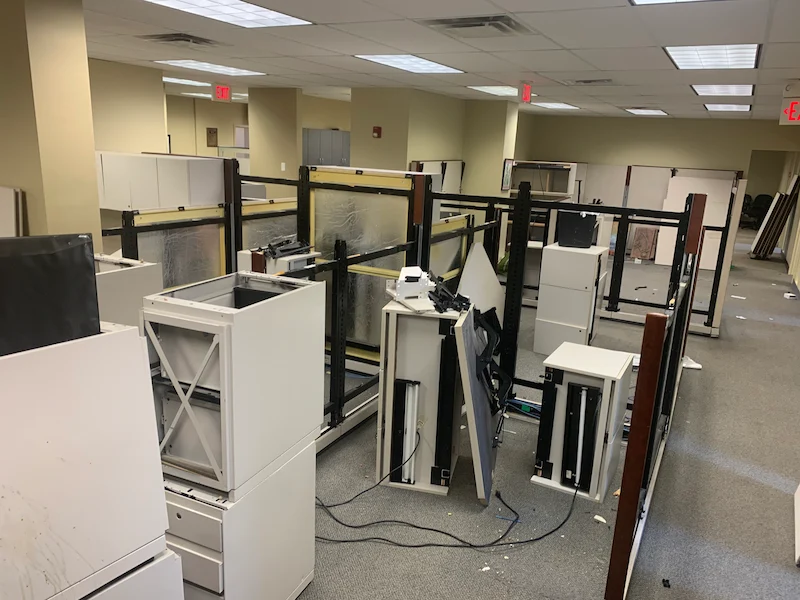 Junk Doctors NJ team breaking down office cubicles and removing electronic waste during a corporate office relocation cleanout.
