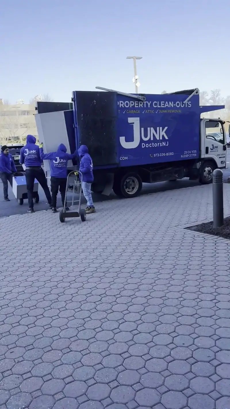 Professional team loading office cabinets and cubicle parts for commercial junk removal in New Jersey.