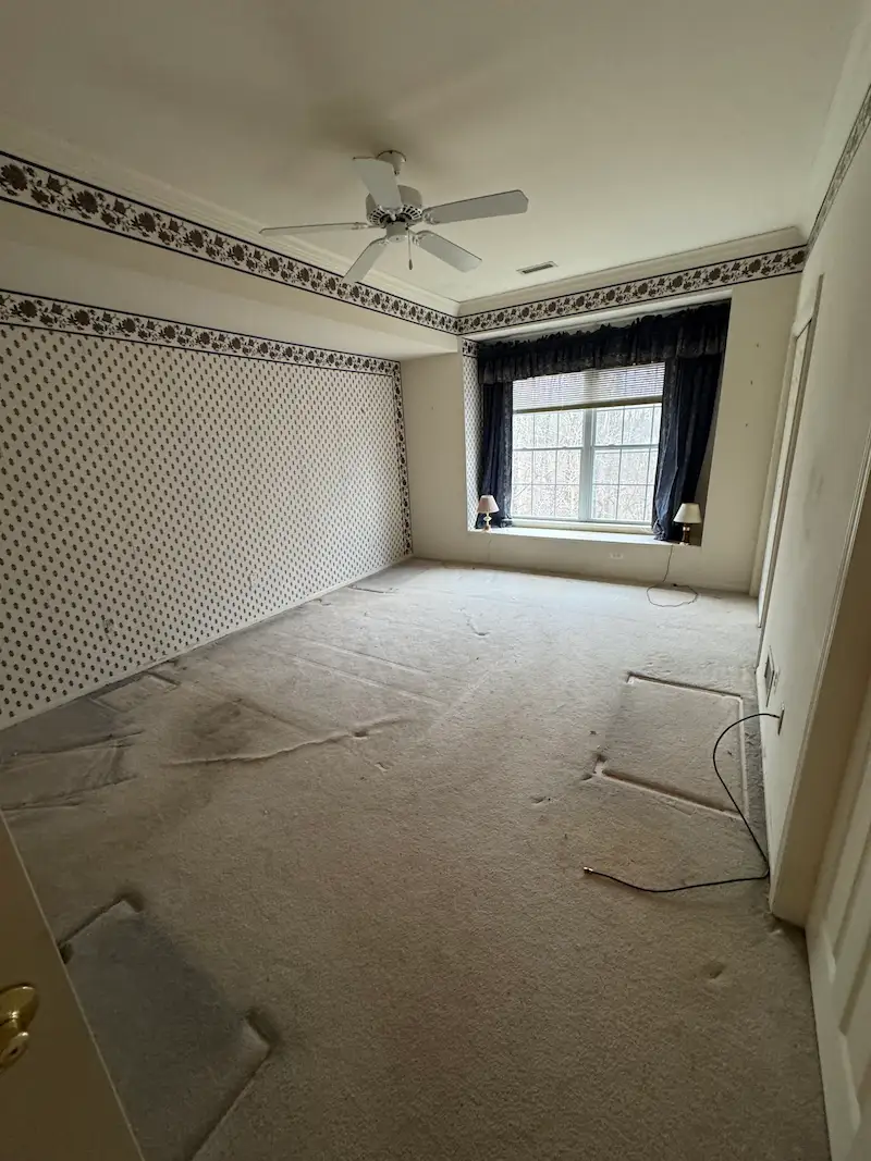 Empty and swept bedroom showing the results of a professional whole-house cleanout service.