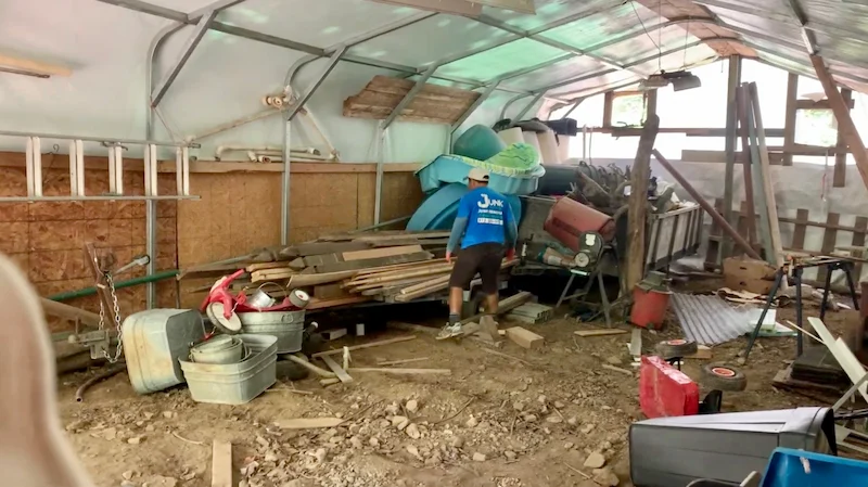 Professional junk removal service in NJ clearing away scrap lumber and construction waste from a residential property.