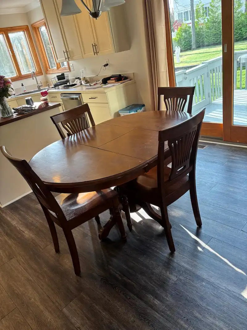 A heavy wooden dining table and chair set in a Madison, North Jersey kitchen before being hauled away by JunkDoctors.