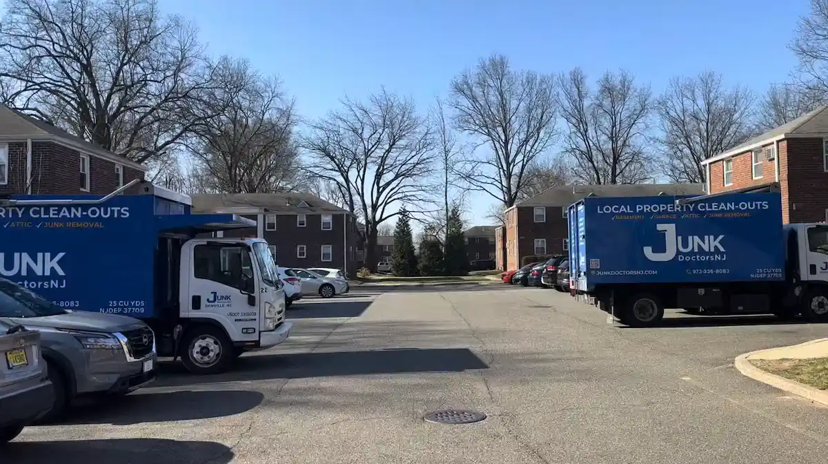 Two large junk removal trucks on-site for a fast emergency clean-out and household debris removal.