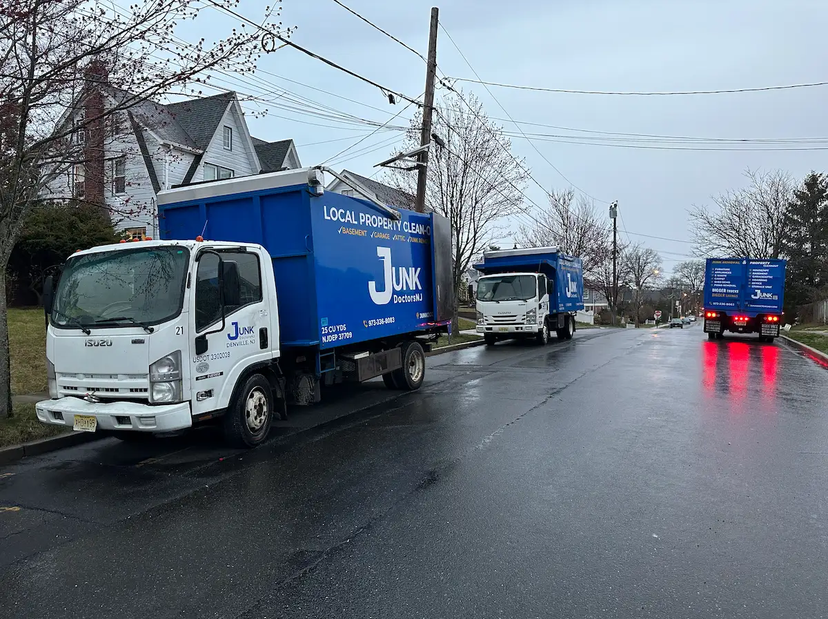 Multiple JunkDoctors trucks arriving on a rainy day to handle an emergency same-day property cleanout in NJ.