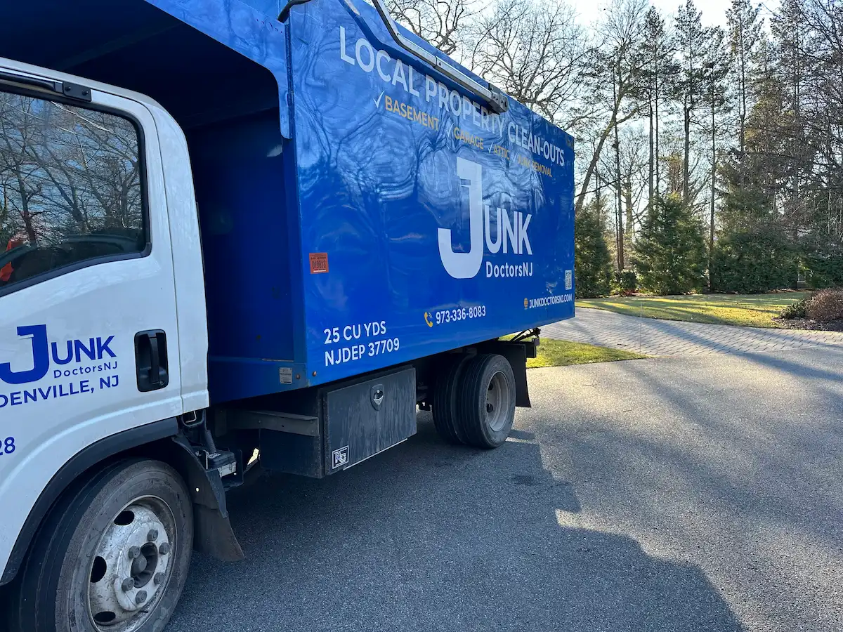 Large Junk Doctors property cleanout truck parked at a premium New Jersey estate, providing professional basement, garage, and attic clearing services.