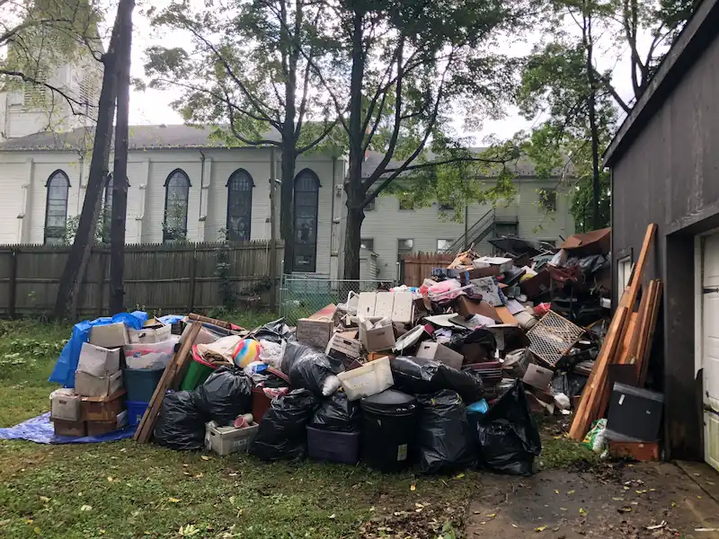 A massive pile of household junk, boxes, and furniture from a North Jersey hoarding cleanup staged for removal by Junk Doctors.