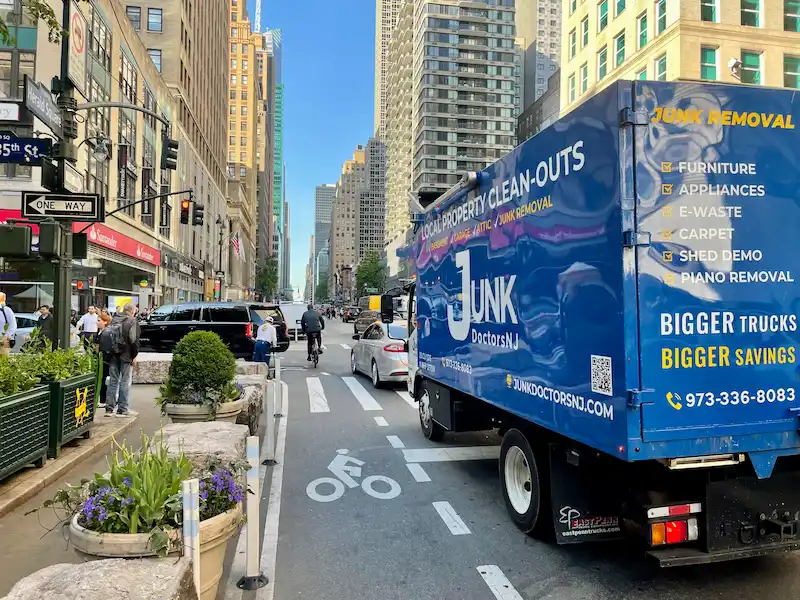 A Junk Doctors NJ truck navigating urban streets to provide efficient commercial debris removal and site cleanup for local businesses.
