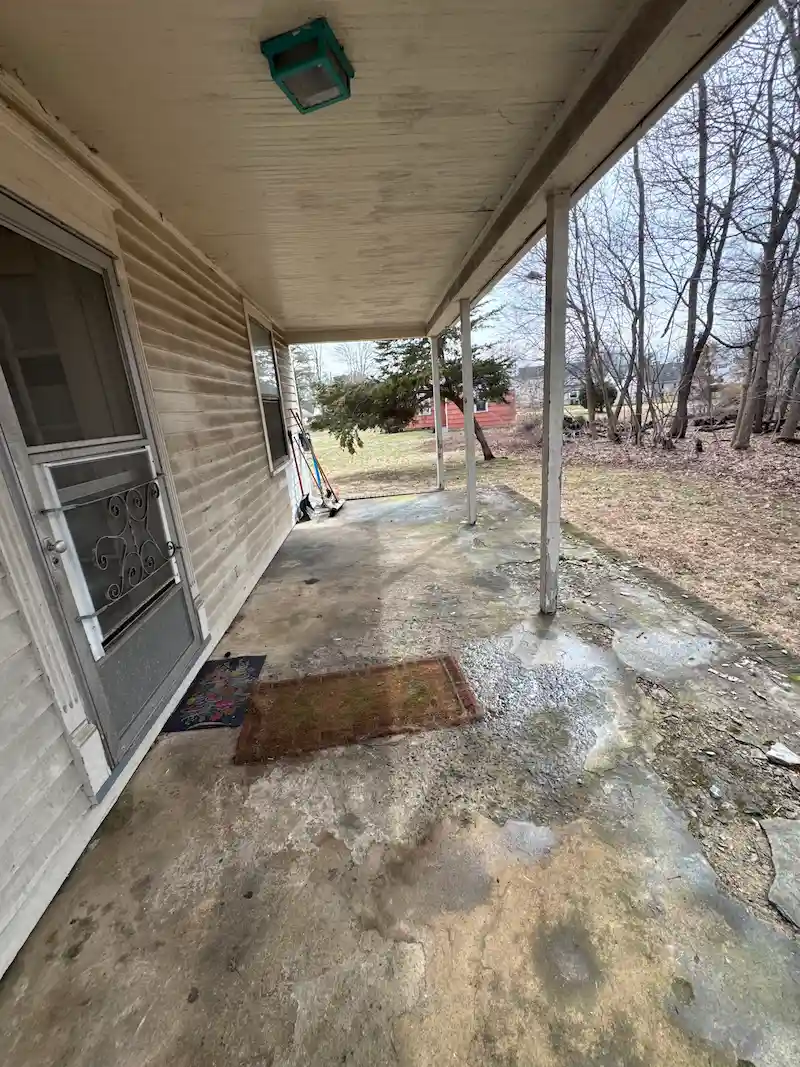 A completely cleared porch in NJ after JunkDoctors hauled away all debris and furniture left behind from an eviction.