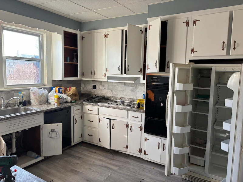 Before shot of a kitchen cleanout in North NJ featuring an old side-by-side refrigerator ready for removal and disposal.