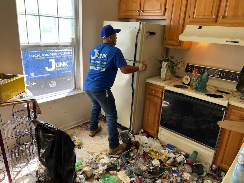JunkDoctors crew removing an old refrigerator from a home.
